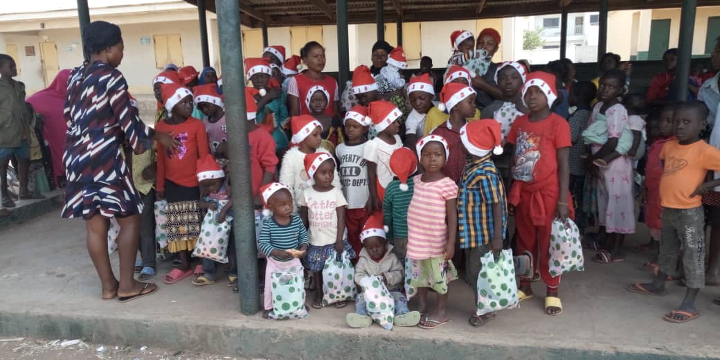 Kids pose for photoshoot with their gifts